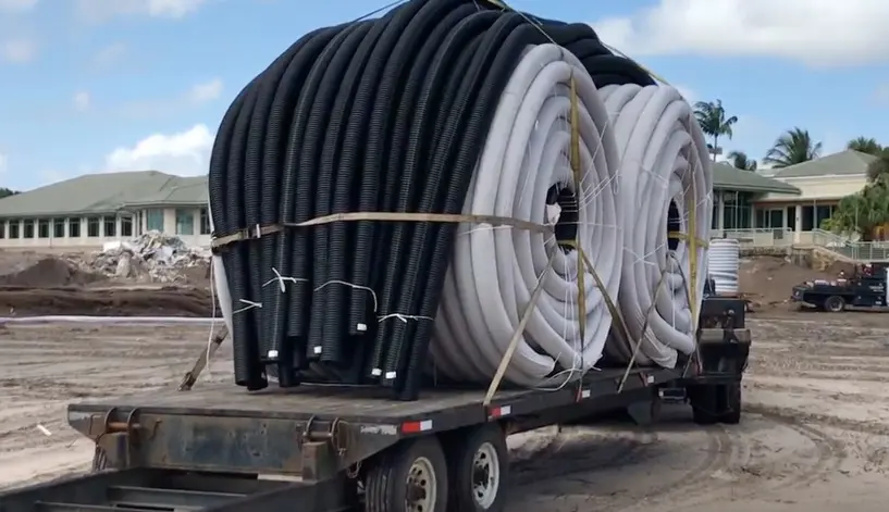 Sock pipe being transported to a sock dewatering site
