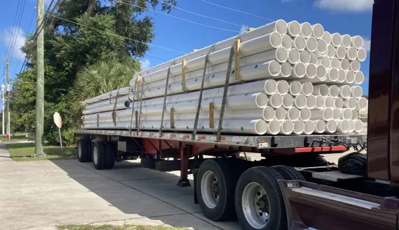 A truck delivering accessories and pipe for a Holland Pump system