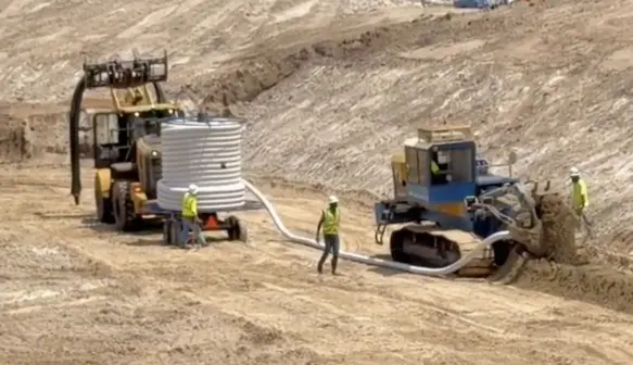 Holland Pump Sock Dewatering Trencher on site