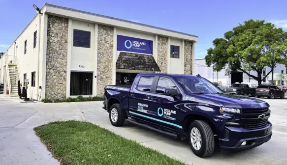 Outside the Holland Pump West Palm Beach branch in Florida with a chevvy truck in Holland Pump branding parked out the front