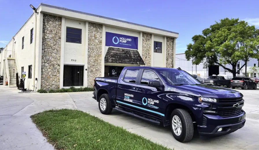 Outside the Holland Pump West Palm Beach branch in Florida with a chevvy truck in Holland Pump branding parked out the front