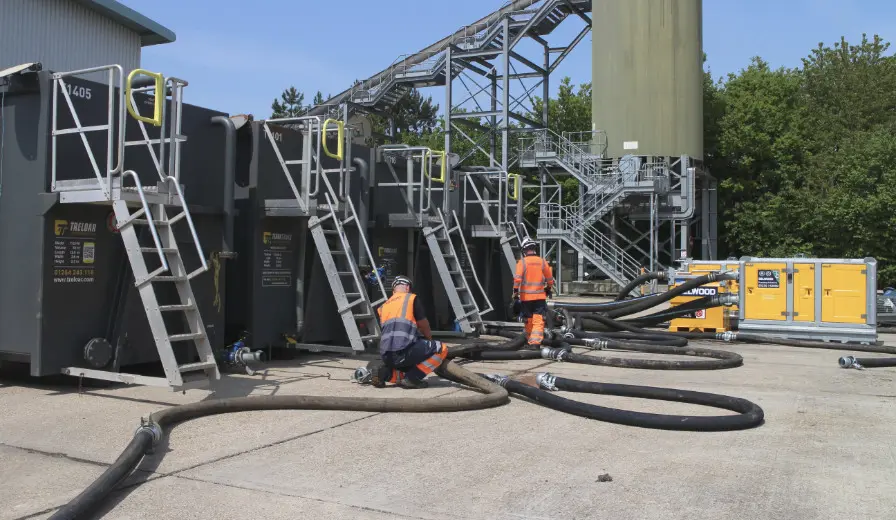 Two Selwood engineers deploying a Selwood pump and pipework on hire at treatment works
